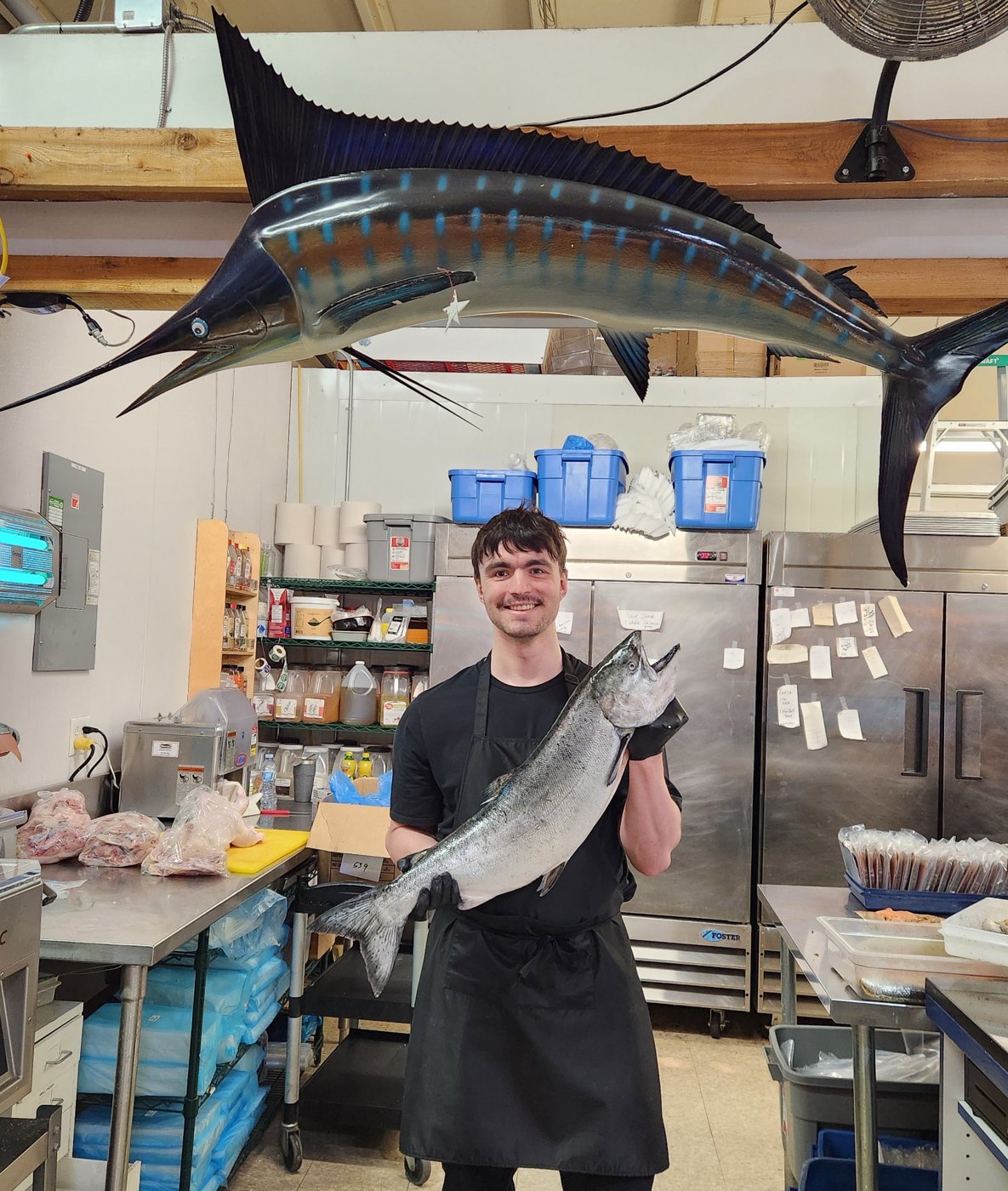 Stuart Davies holding a salmon at the fish market